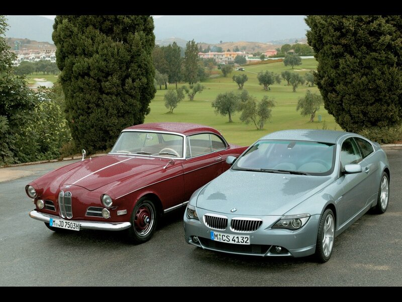 Two BMW cars on a golf course