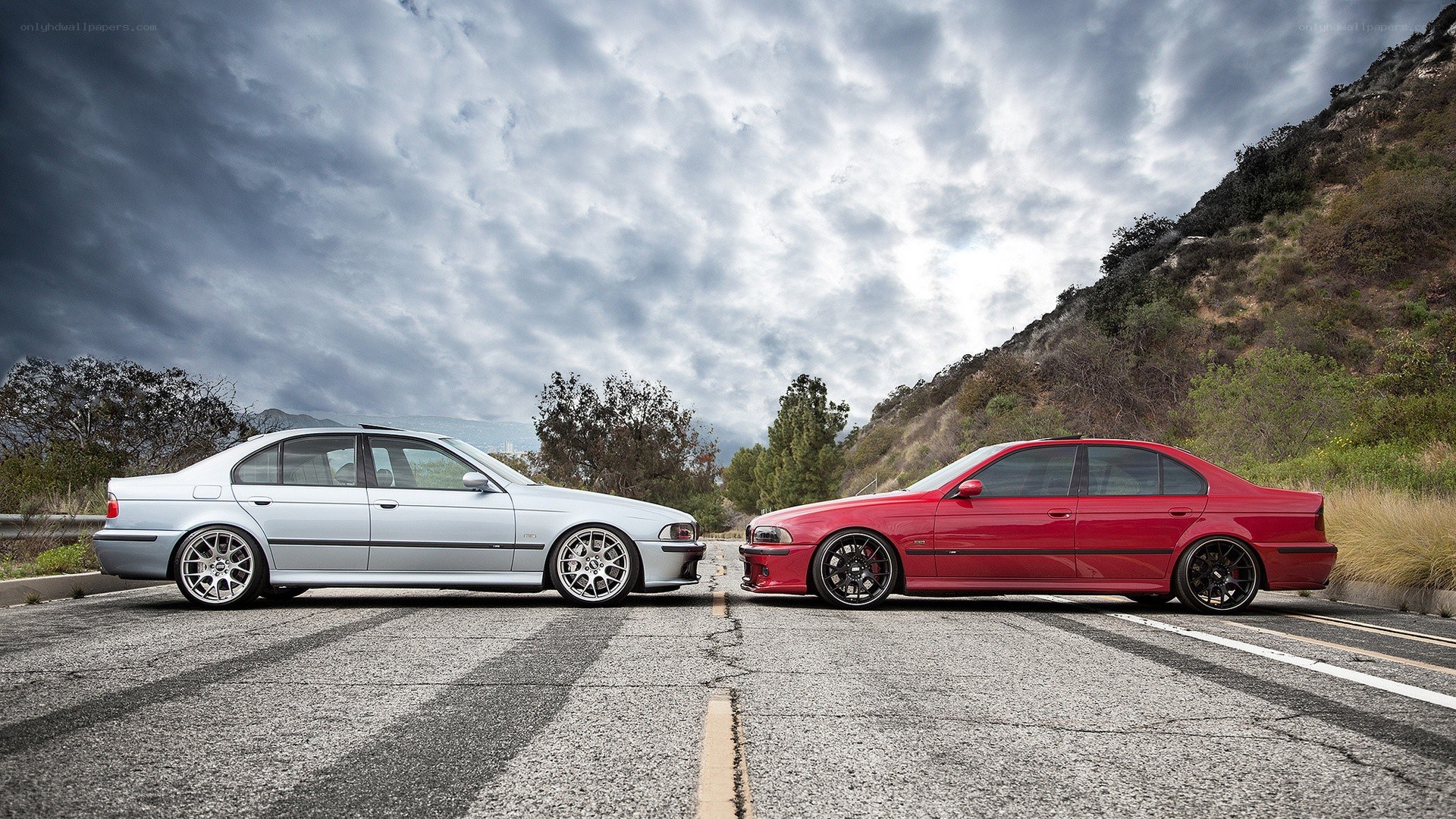 Two BMW cars on a road