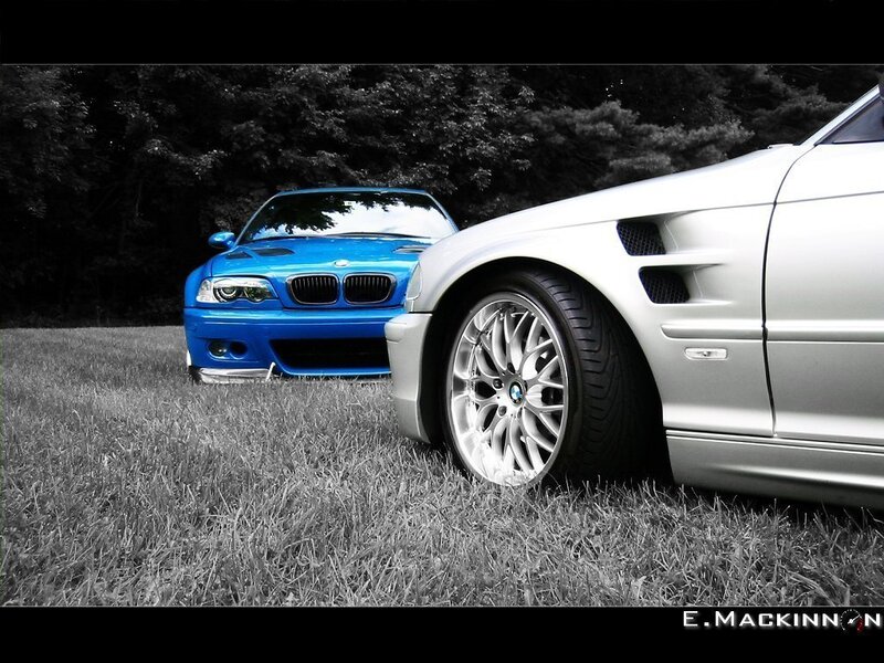 Two BMW cars on grass