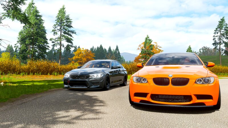 Two BMW Cars on Road — Orange