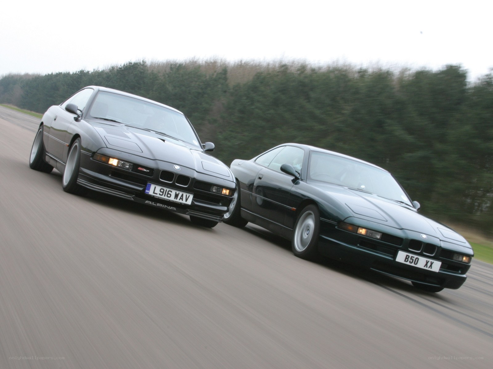 Two BMW coupes on a road