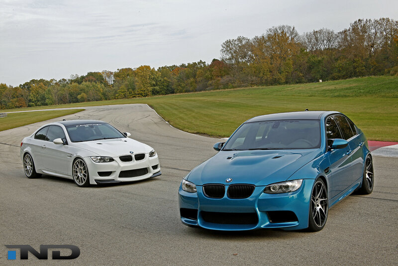 Two BMW M3 cars on a racetrack
