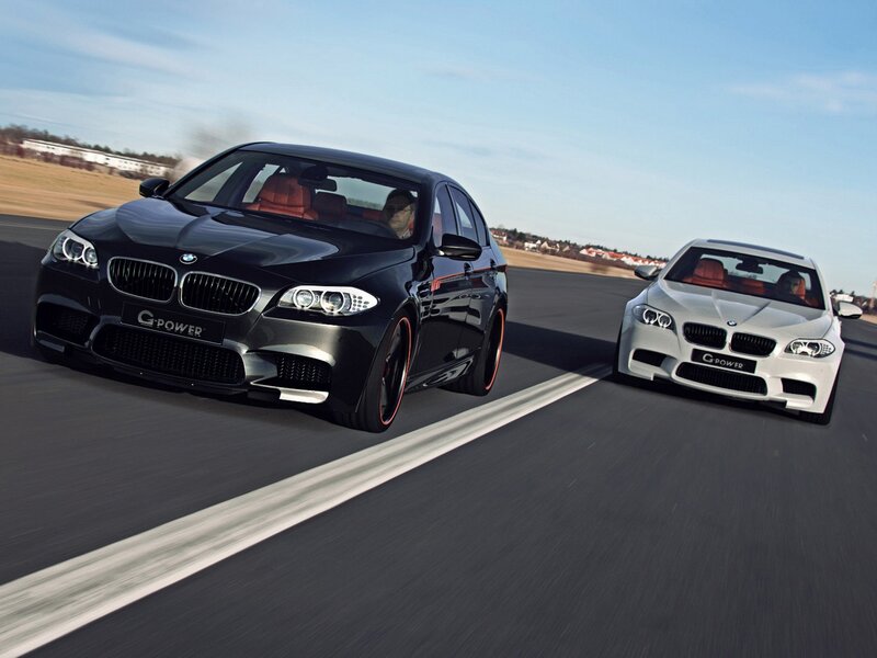 Two BMW M5 cars on a track