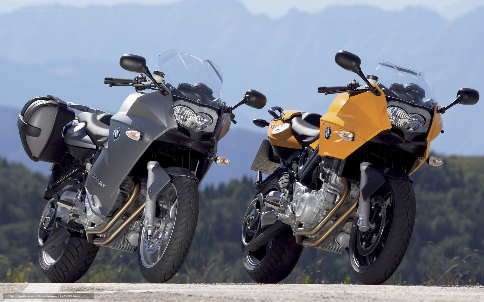 Two BMW motorcycles on a road