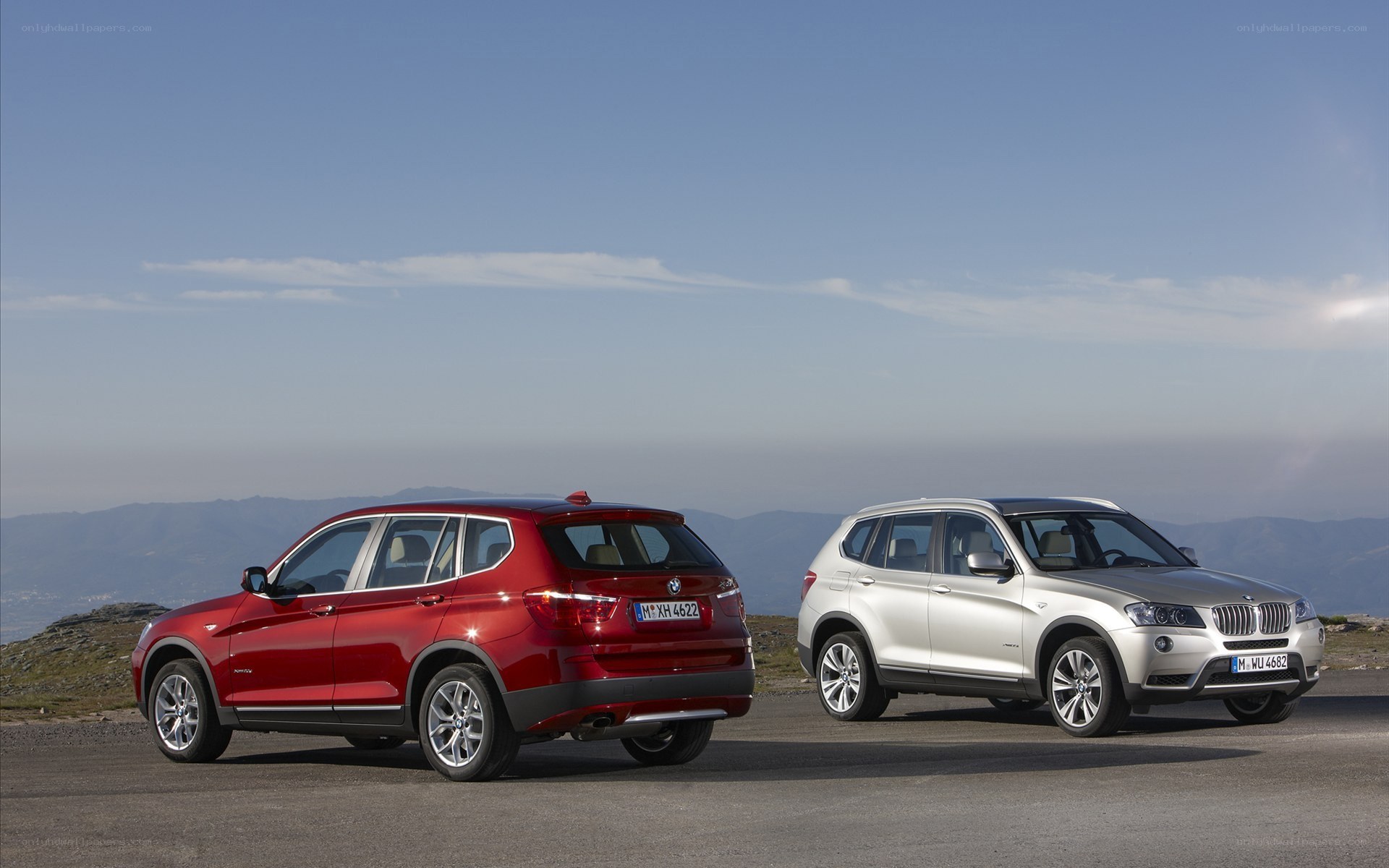 Two BMW SUVs on a mountain road