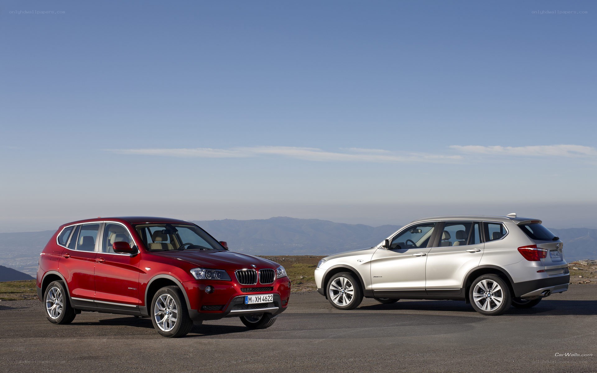 Two BMW SUVs on a mountain road