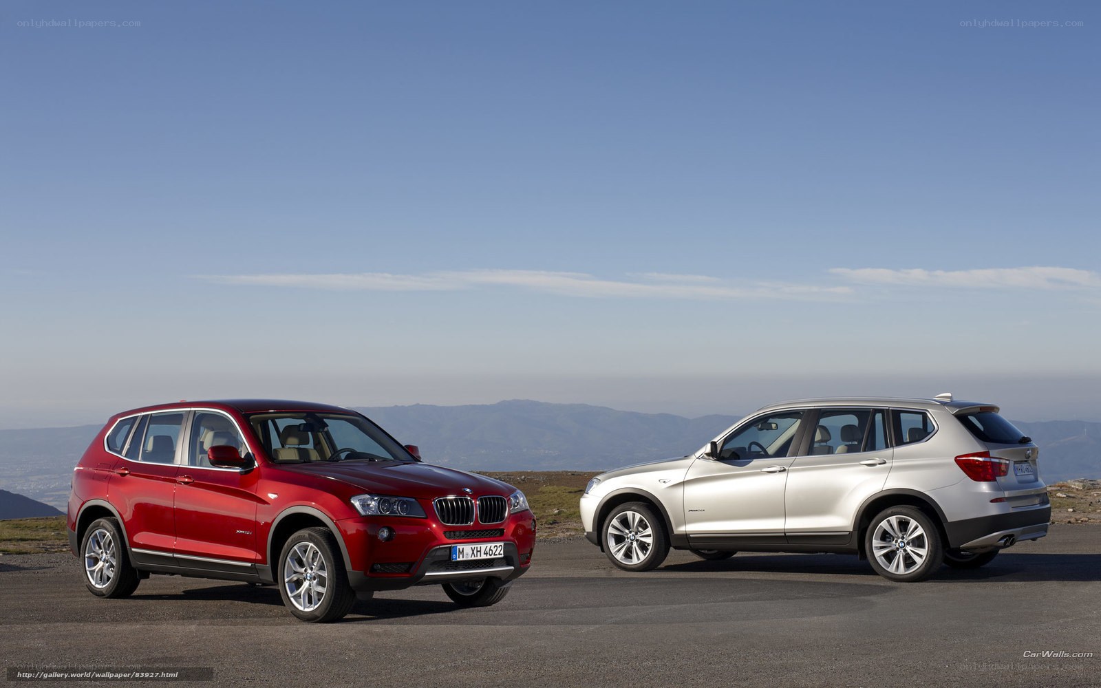 Two BMW SUVs on a mountain road