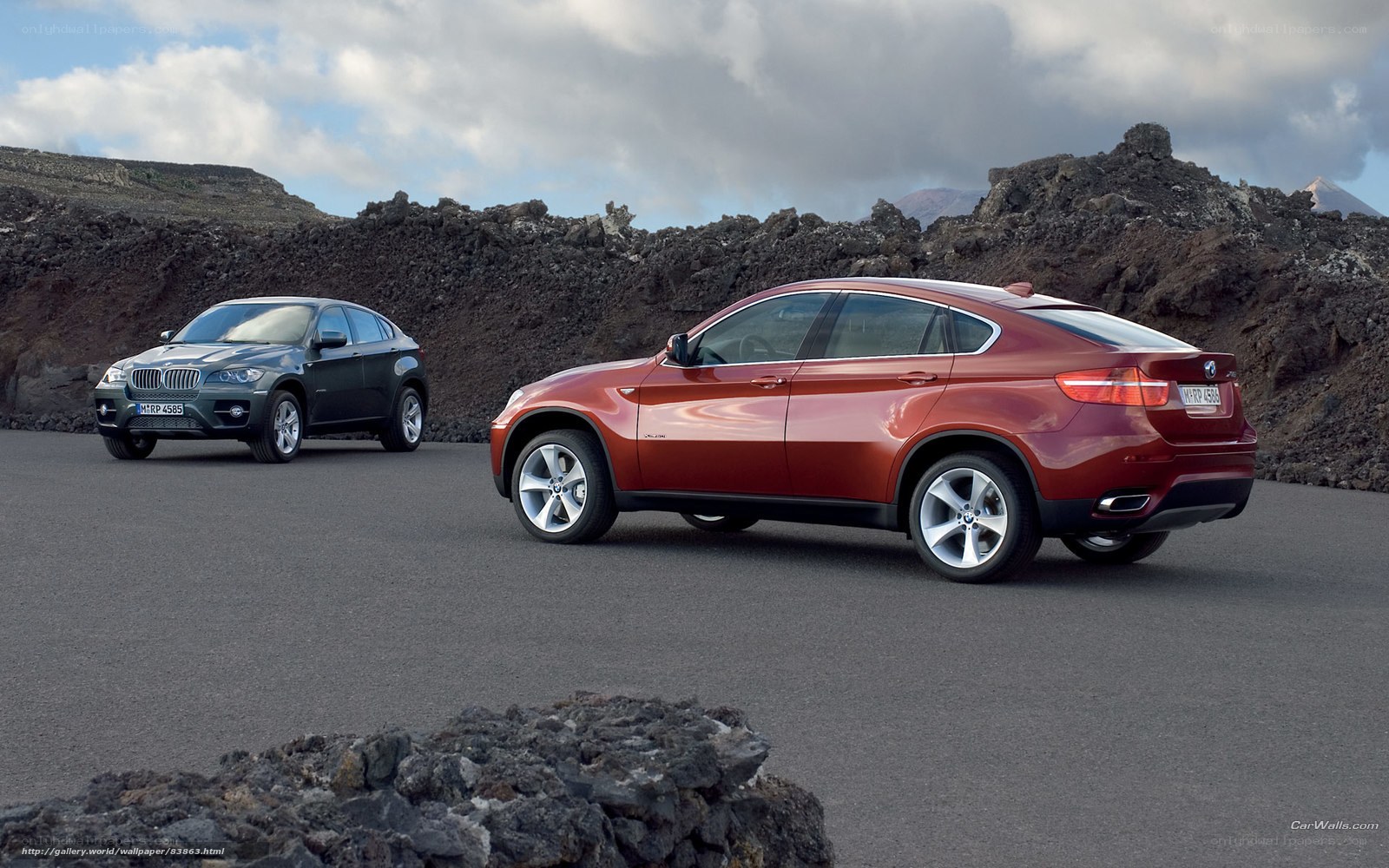 Two BMW SUVs on a volcanic road
