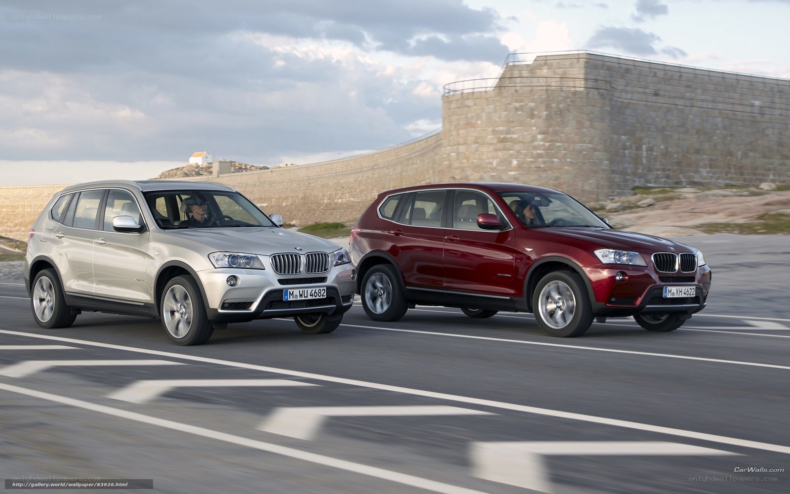 Two BMW X3 SUVs on a coastal road