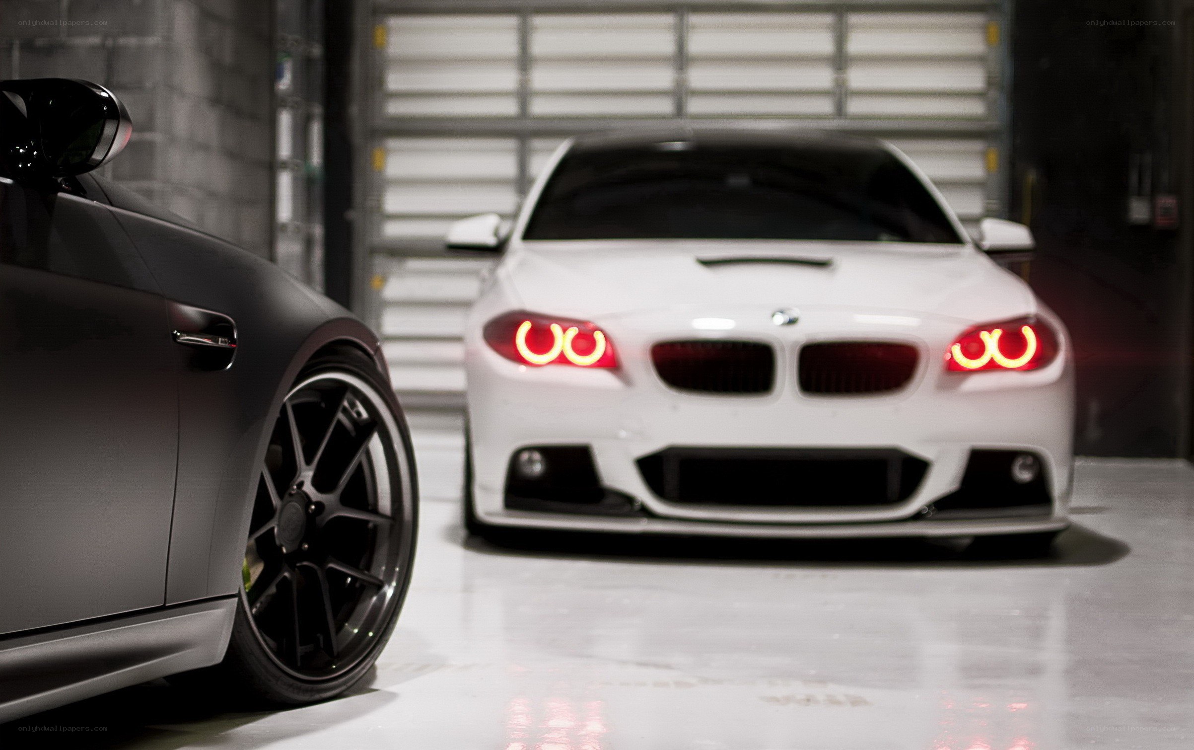 Two BMWs in a garage