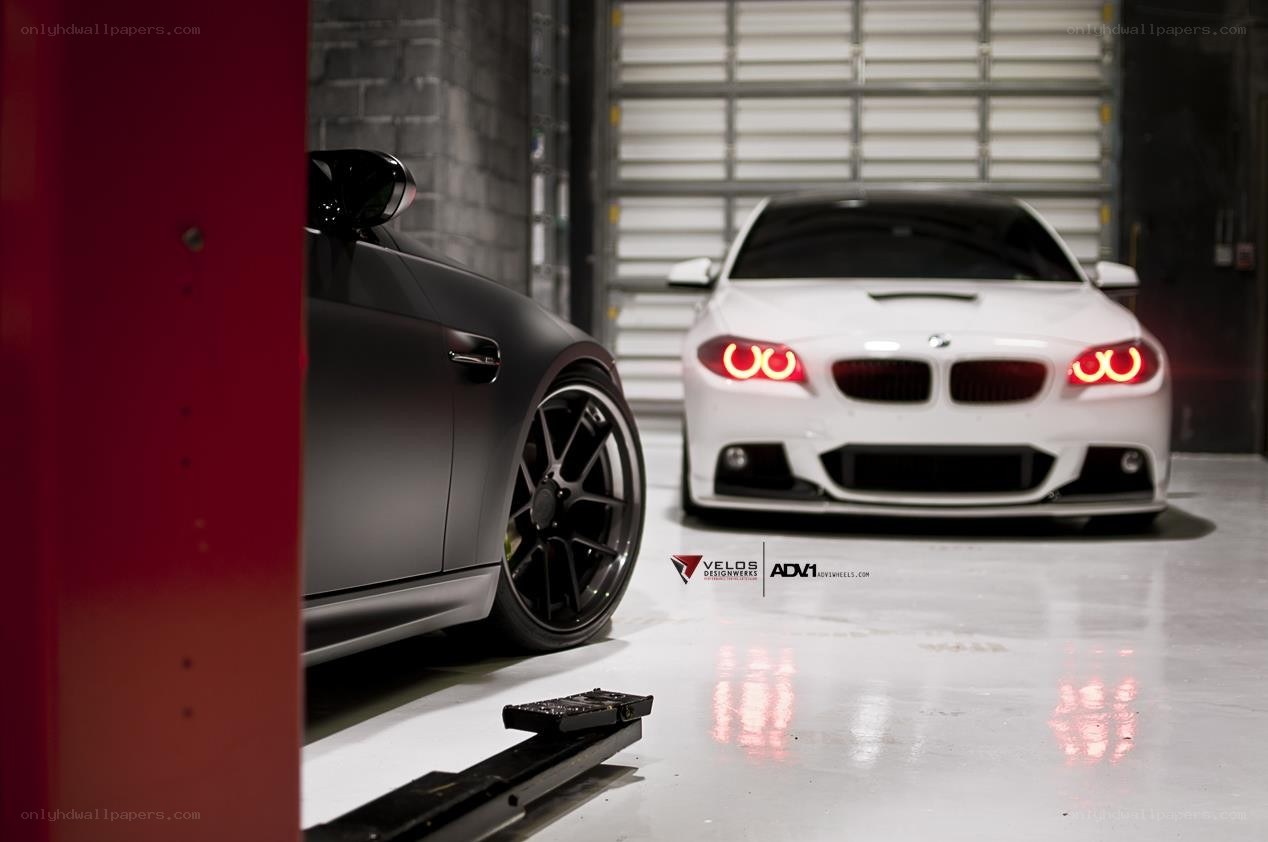 Two BMWs in a garage
