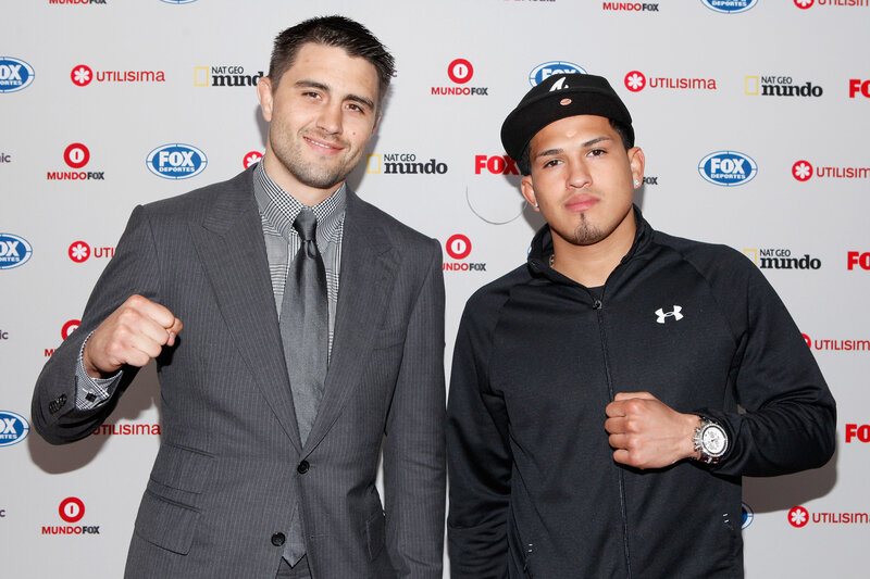 Two boxers pose at event