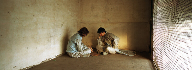Two boys in a dim room