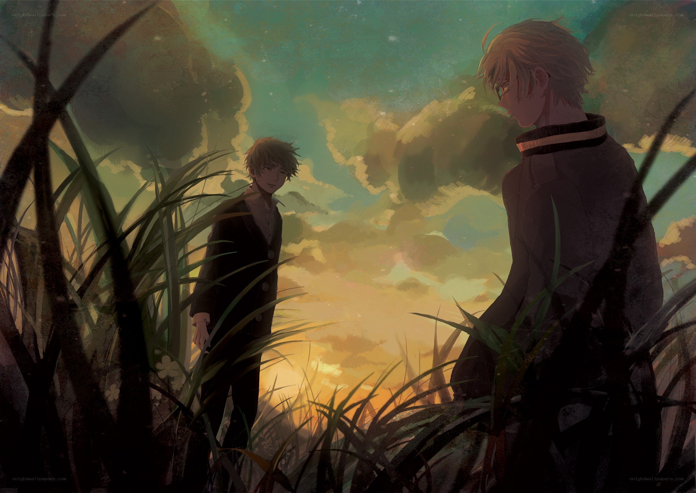 Two boys in a field at sunset