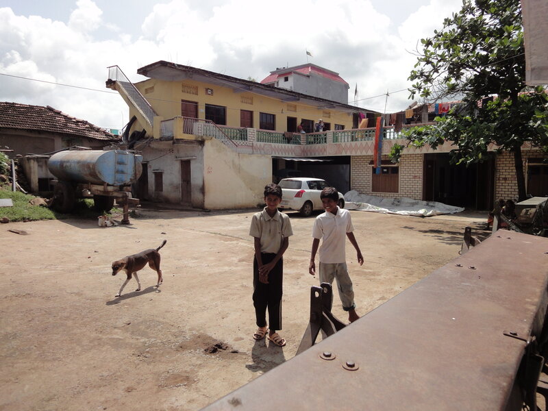 Two boys in a village courtyard