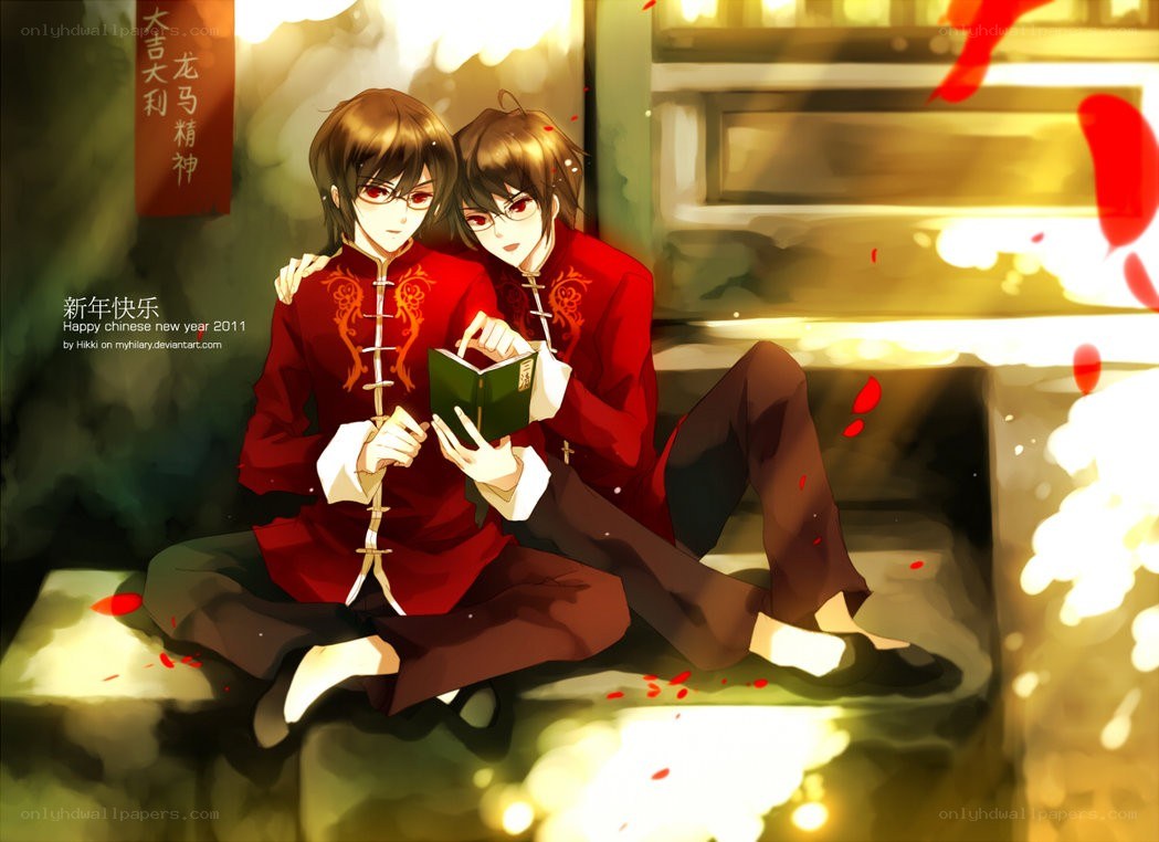 Two boys in red outfits reading