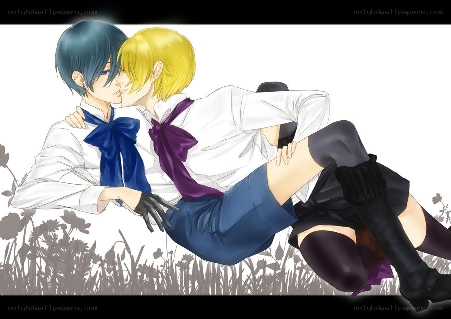 Two boys kissing in a field