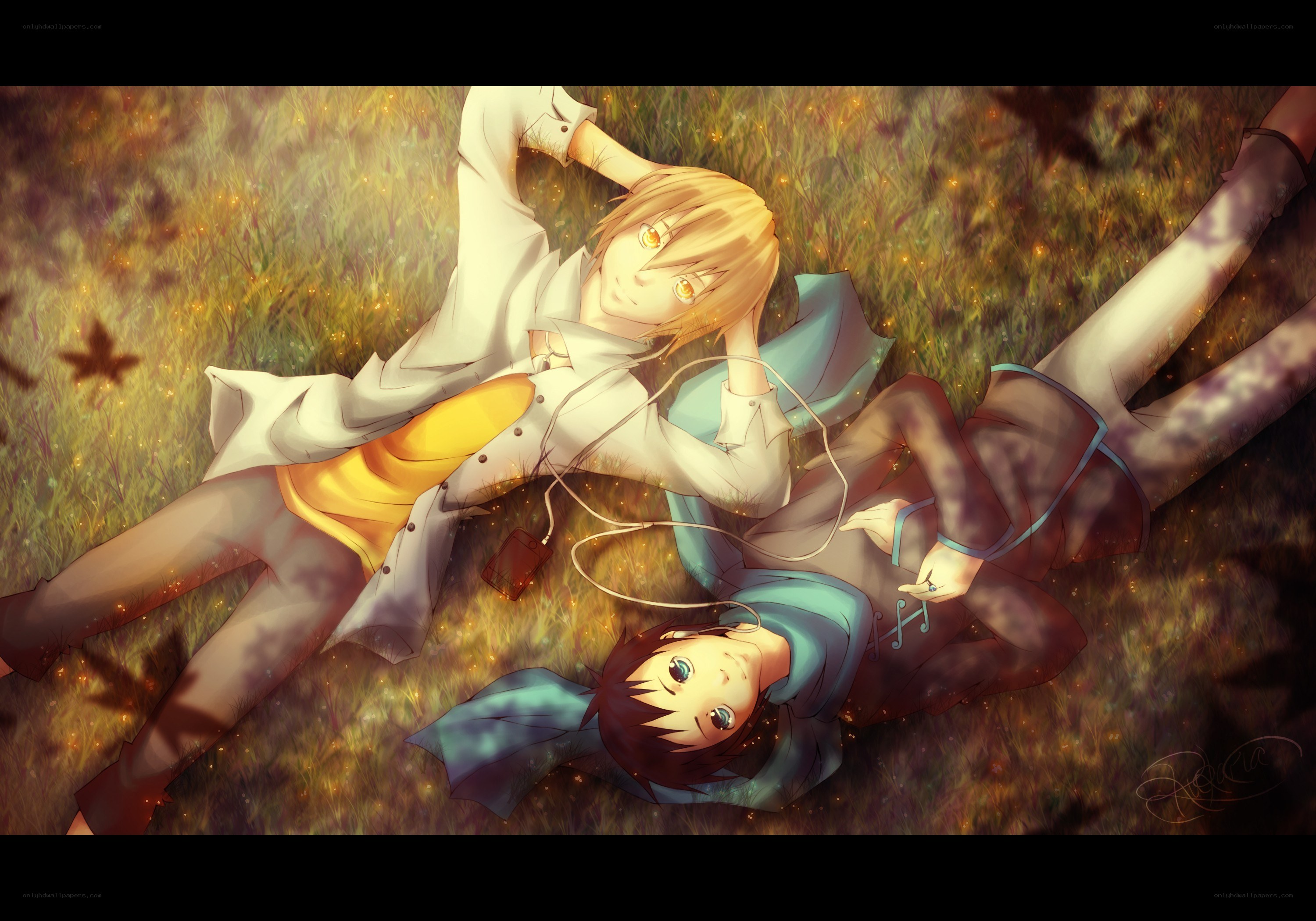 Two boys lying in a field