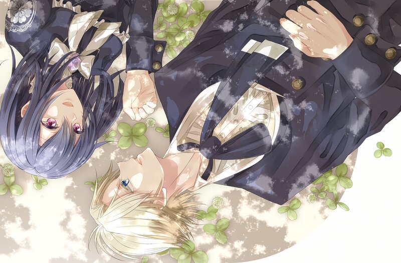 Two boys lying on clovers