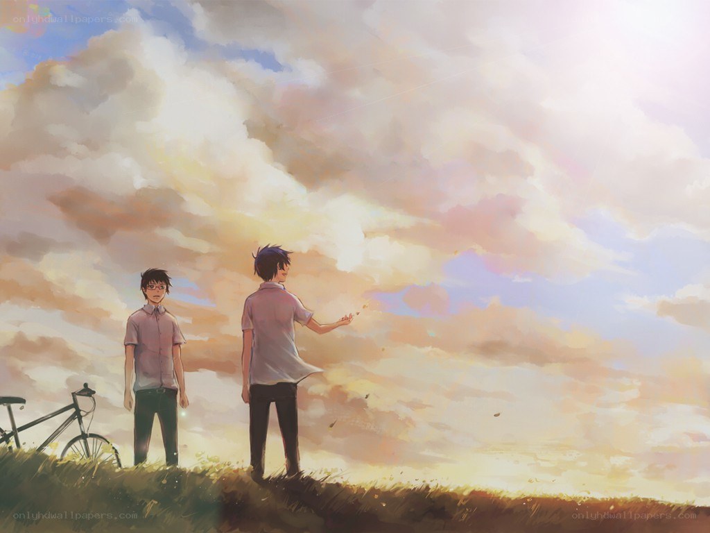 Two boys on a hill at sunset
