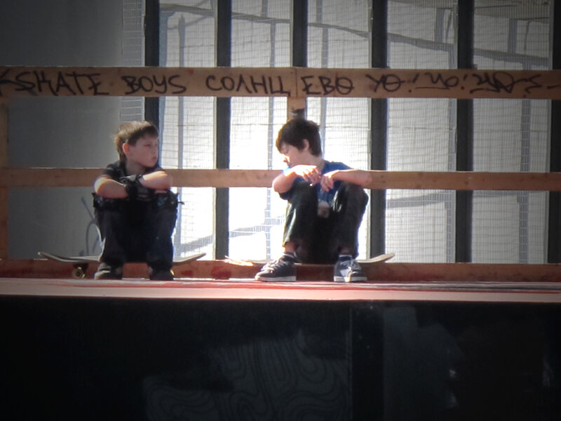 Two boys on a skate ramp