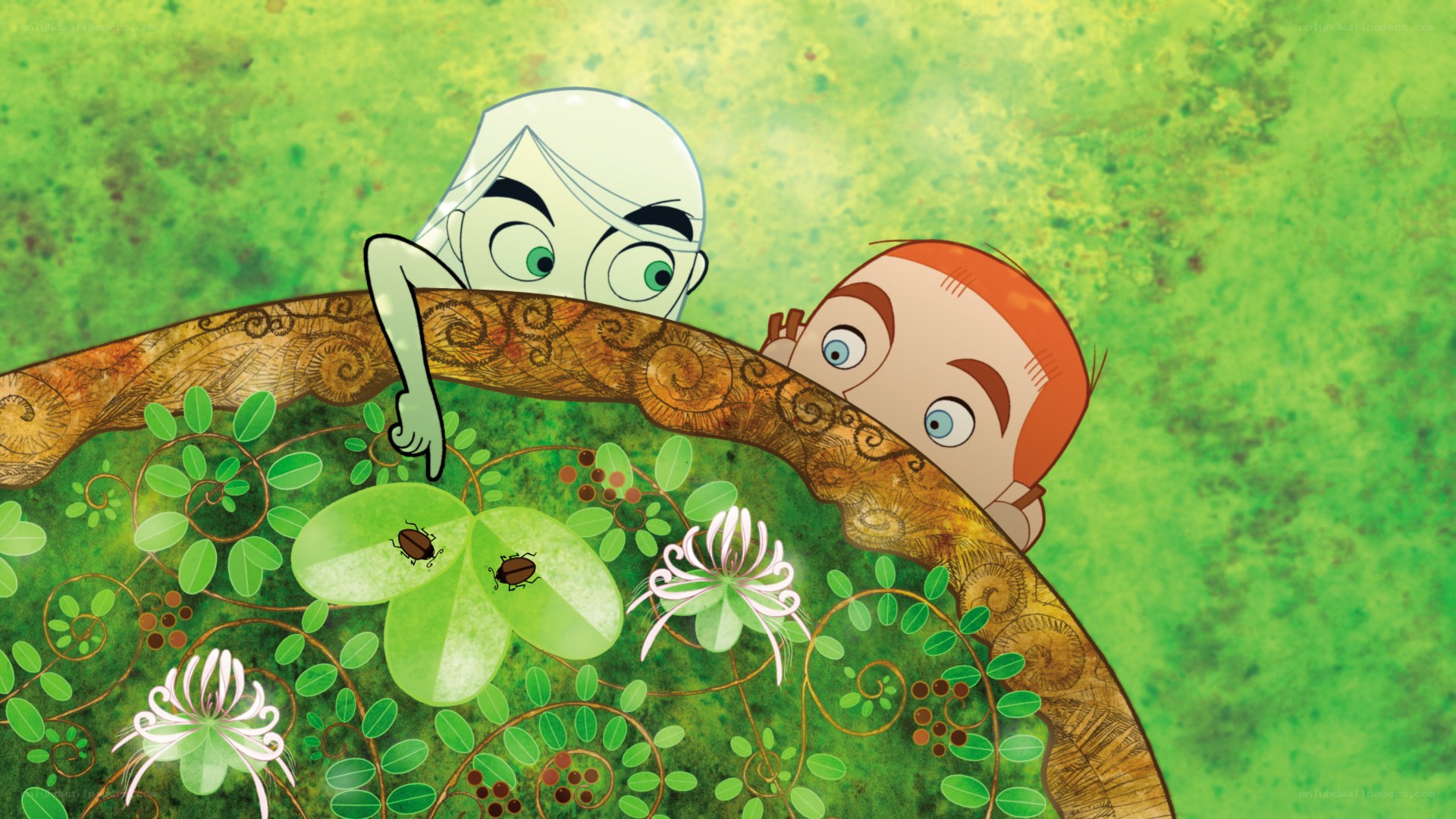 two boys peeking over a plant