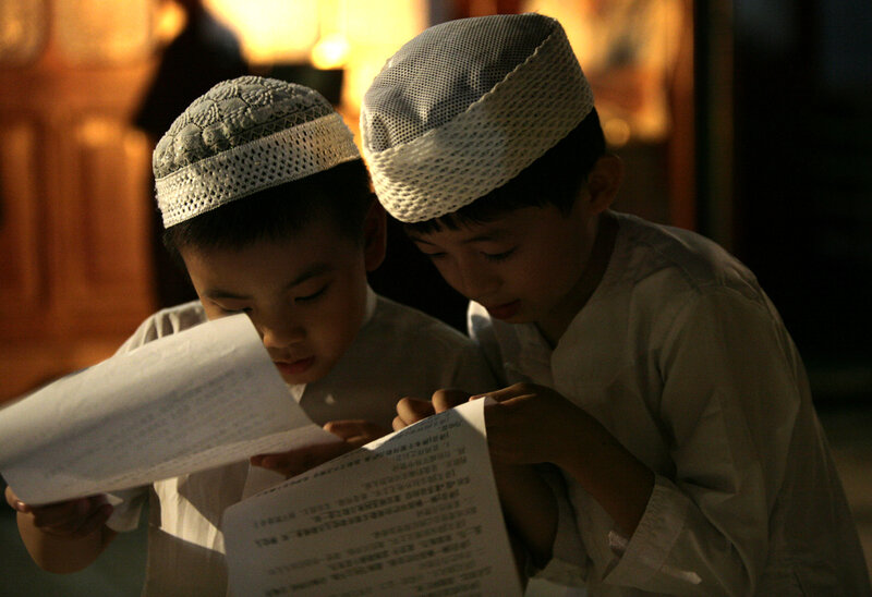 Two Boys Reading Papers