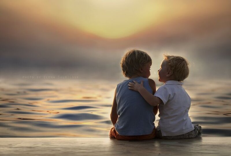 Two Boys Sitting by Water