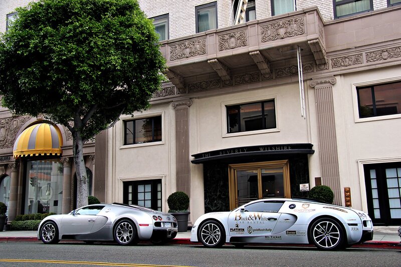 Two Bugatti Veyrons outside a hotel