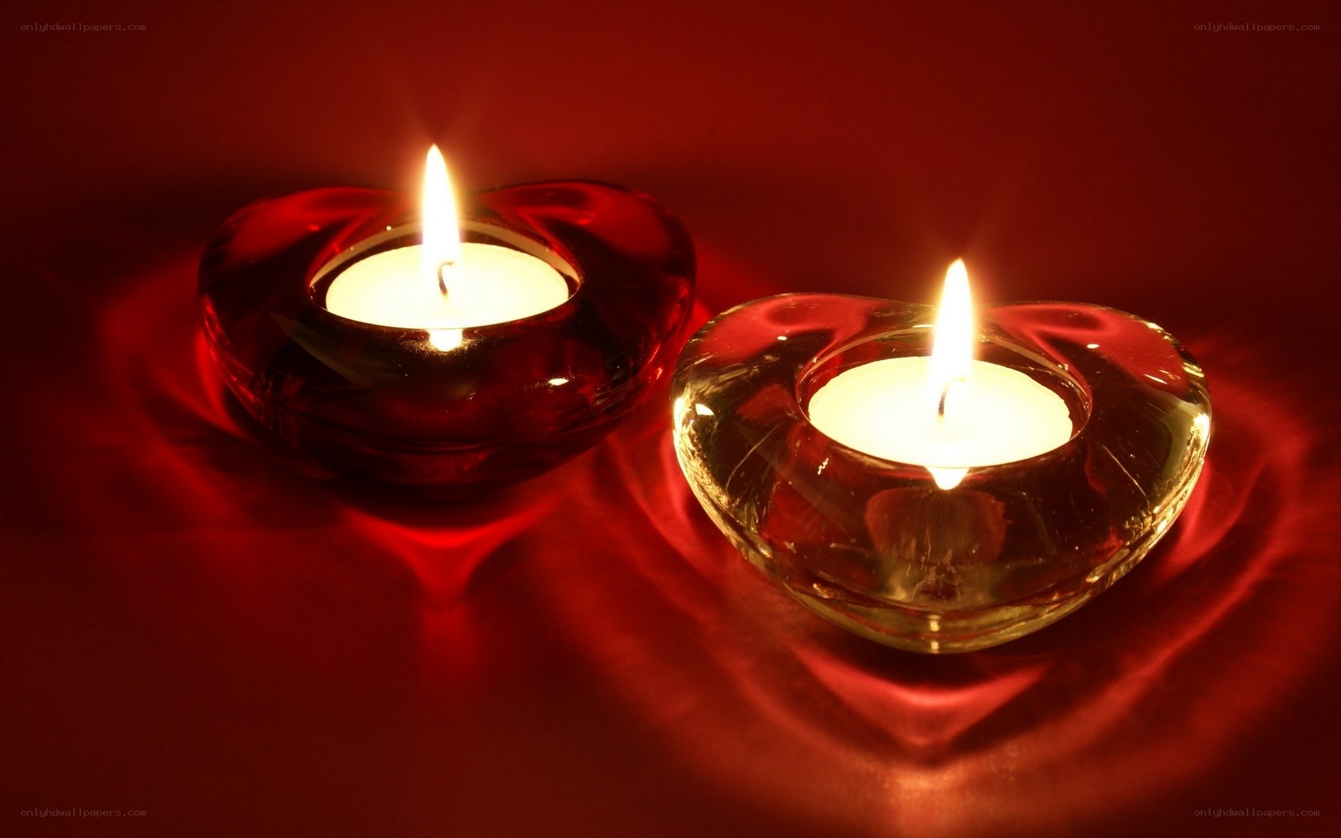 Two candles in heart holders