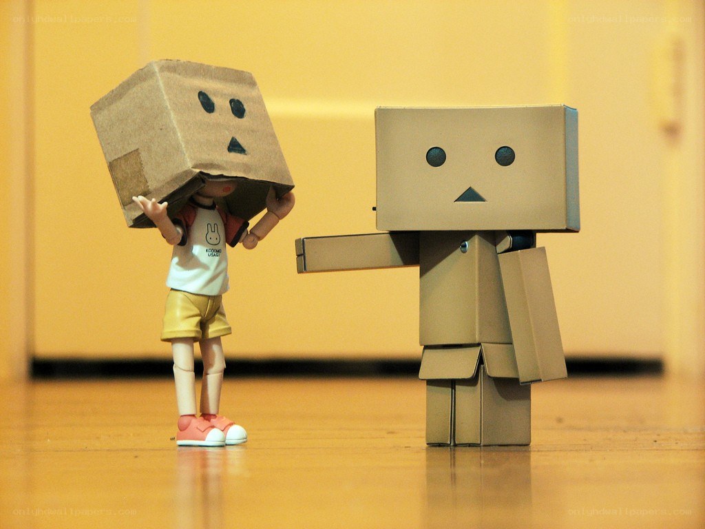 Two cardboard box figures interacting