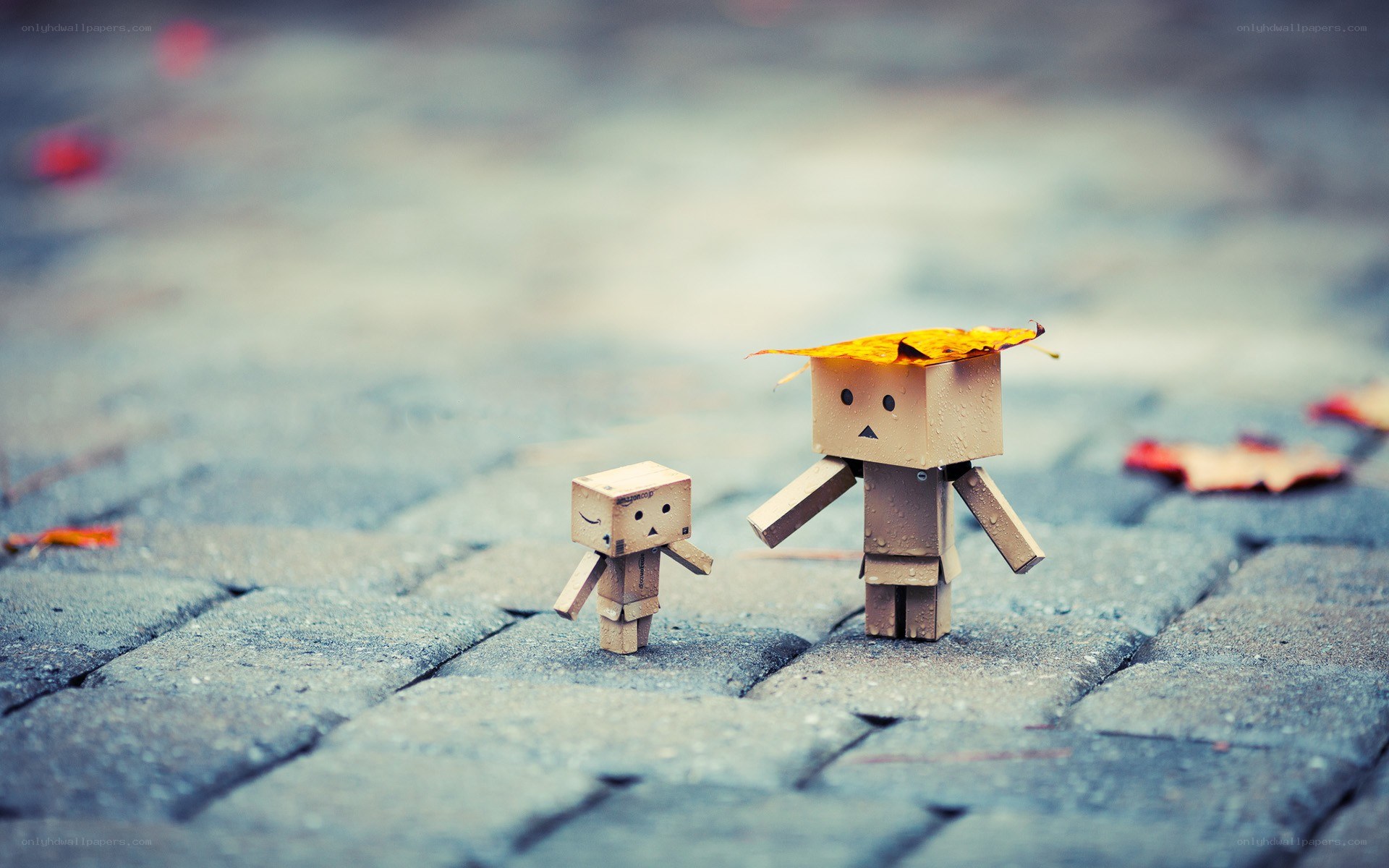 Two cardboard figures on pavement