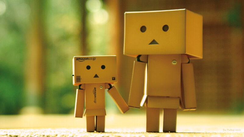 Two Cardboard Robots Holding Hands — Brown