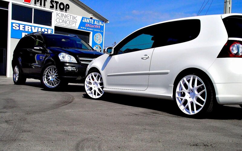 Two cars at a service station