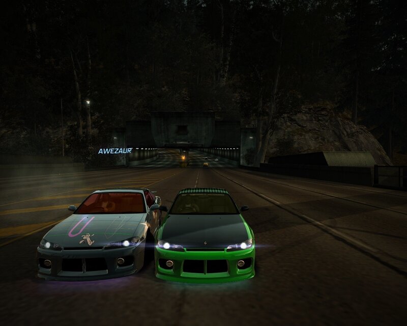Two cars at night on a road