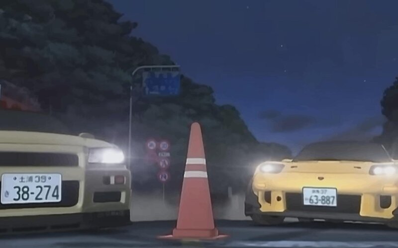 Two cars at night on a road