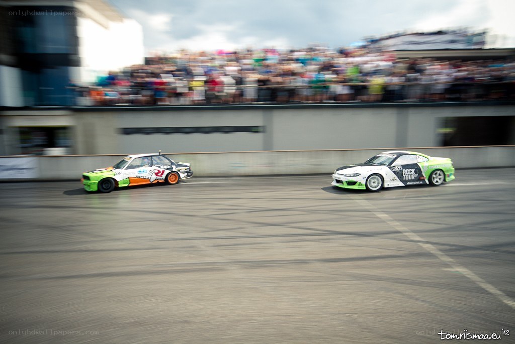 Two cars drifting at a race