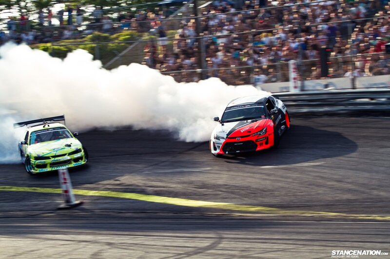 Two cars drifting at a race