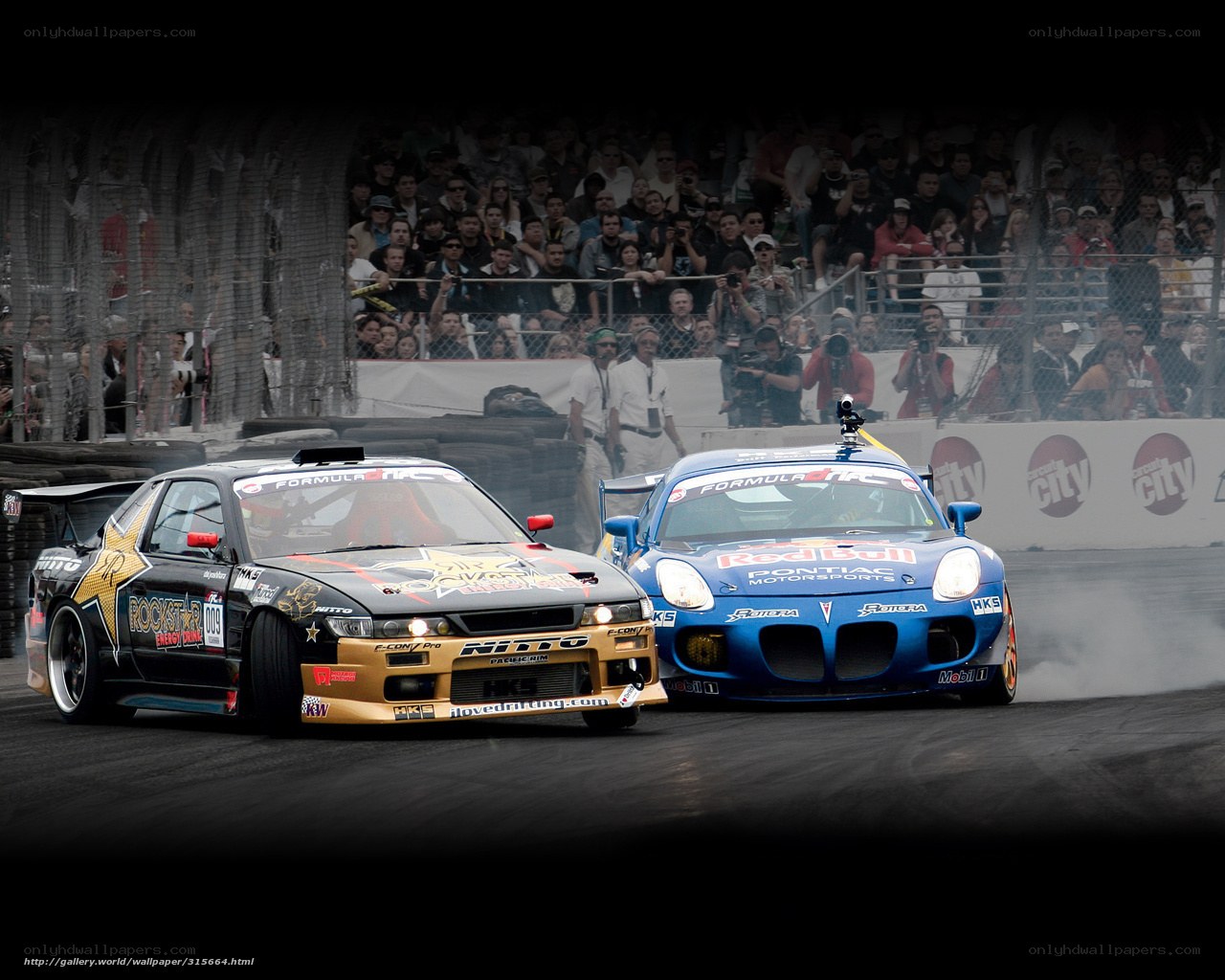 Two cars drifting at a race