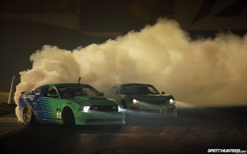 Two cars drifting at night