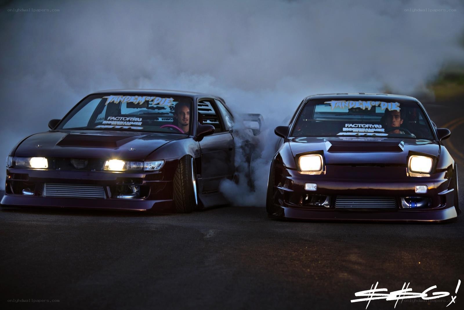 two cars drifting at night