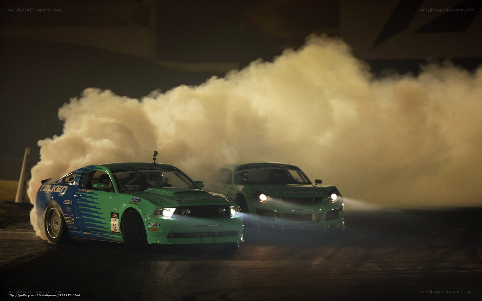 Two cars drifting at night