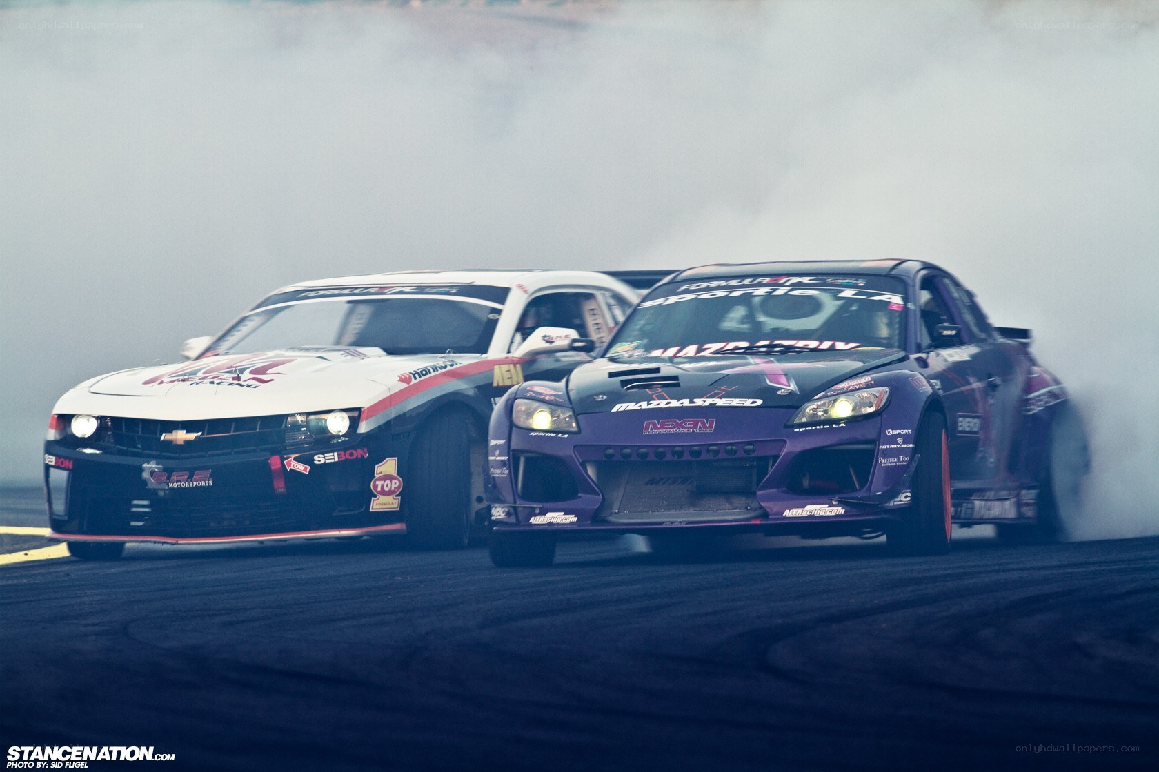 Two cars drifting on a track