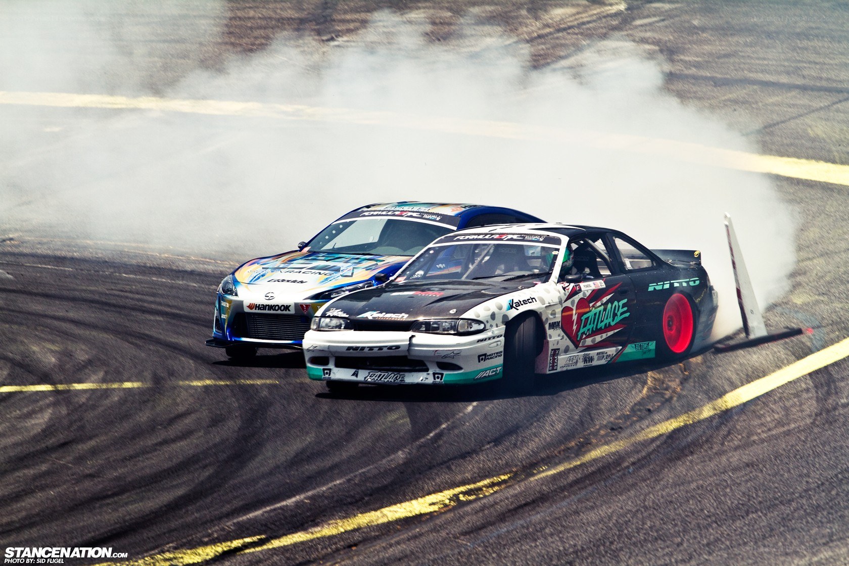 Two cars drifting on a track