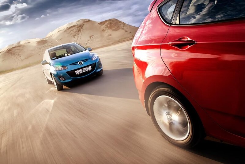 Two cars driving on a desert road