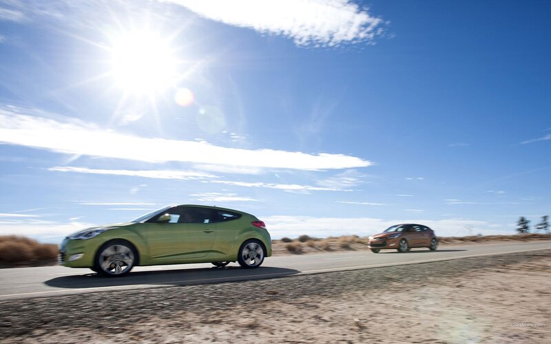 Two cars driving on a sunny road