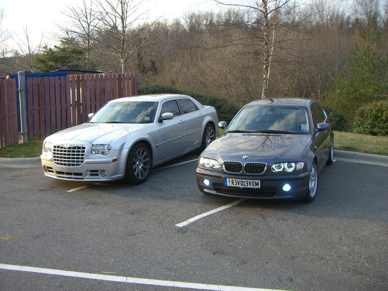 Two cars parked in a lot