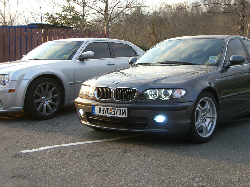 Two cars parked in a lot