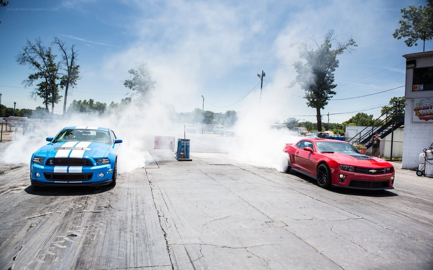 Two cars performing burnouts