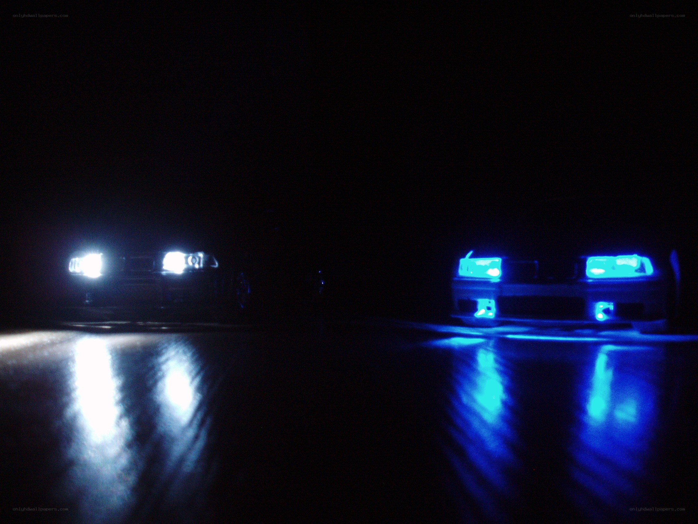 Two cars with headlights on